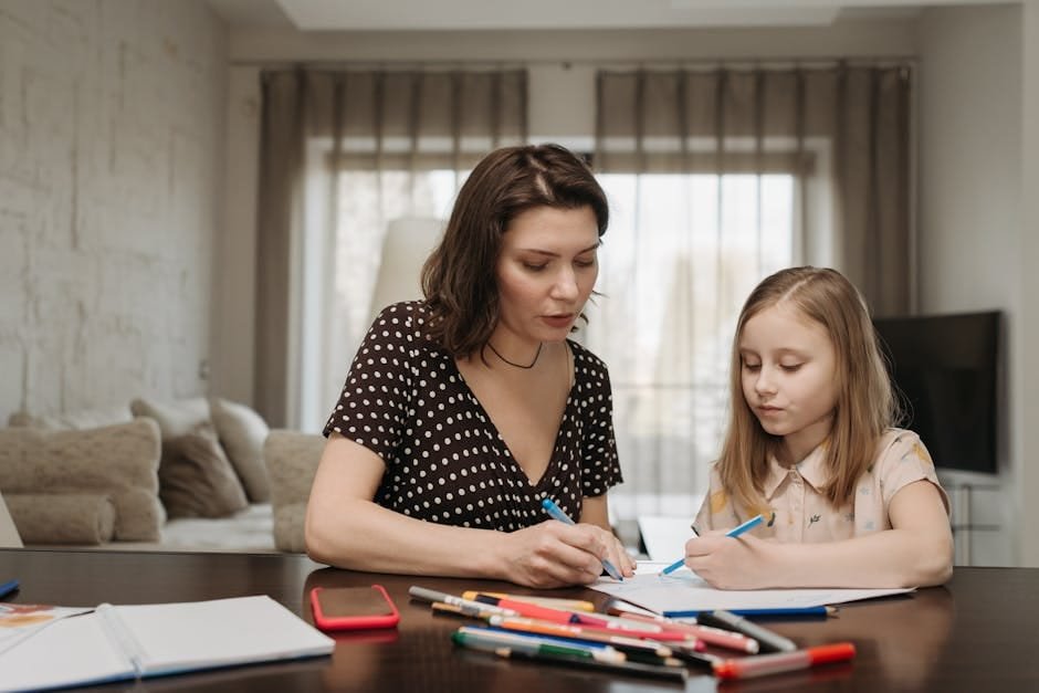 A mother and daughter sit together at home, drawing and spending quality time.